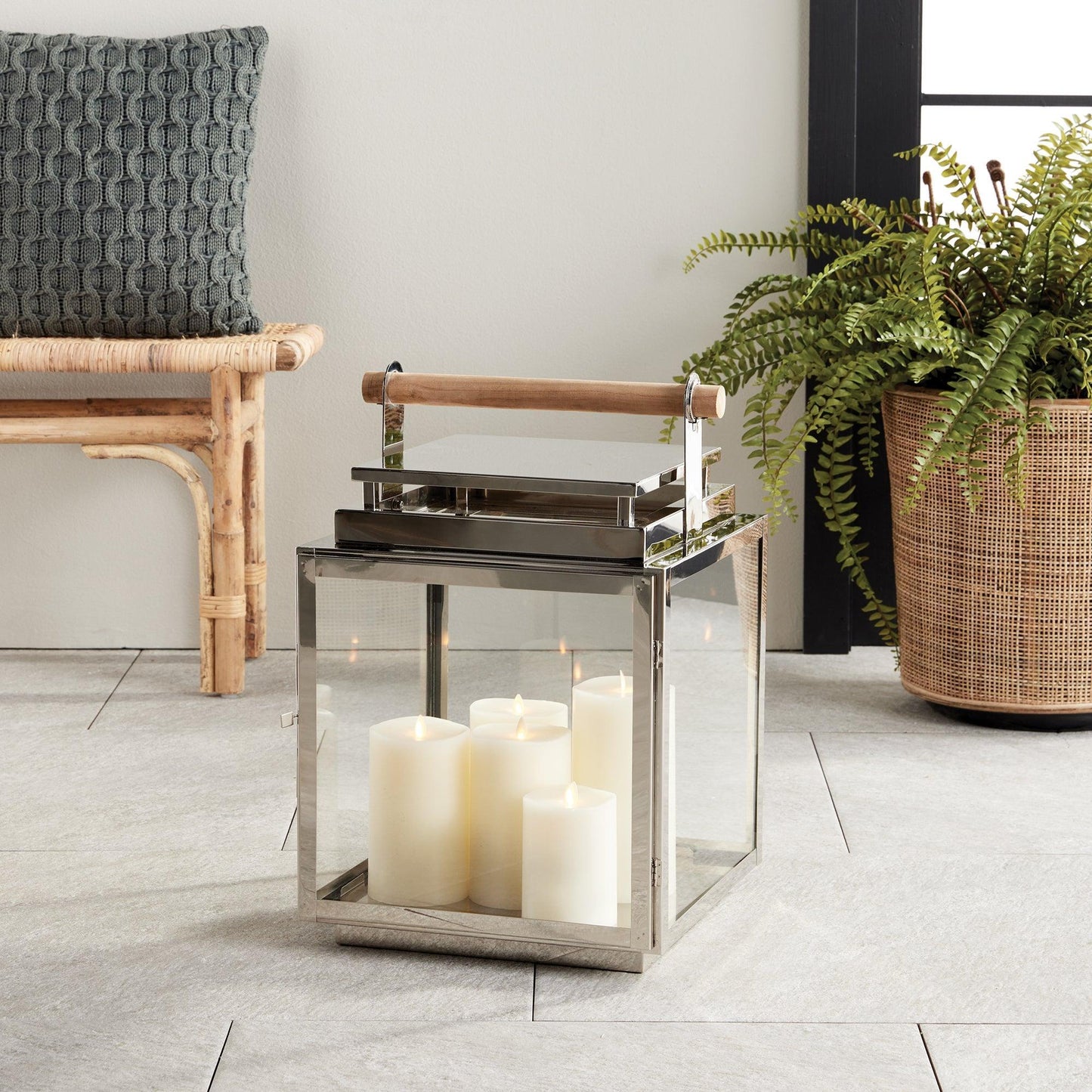 Silver lantern with wood handle in a living room 