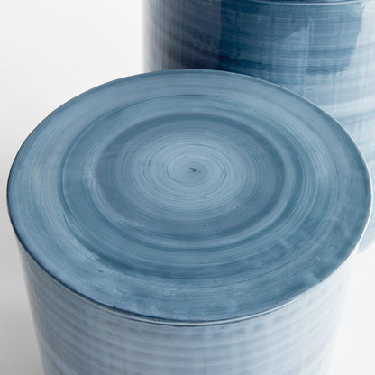 Top of side table painted with a blue swirl. 