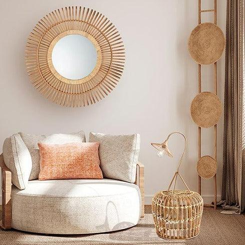 Bamboo mirror in a room with a big chair 