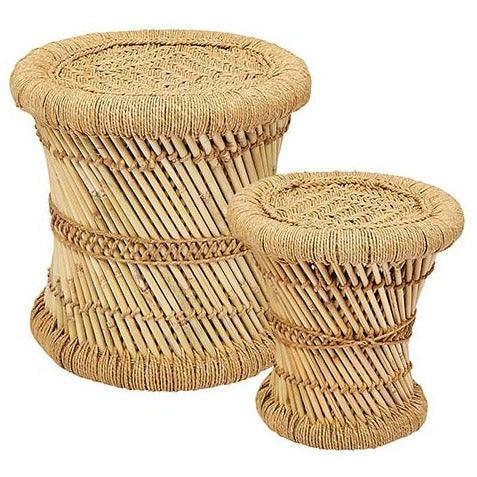 a set of two wicker stools sitting next to each other