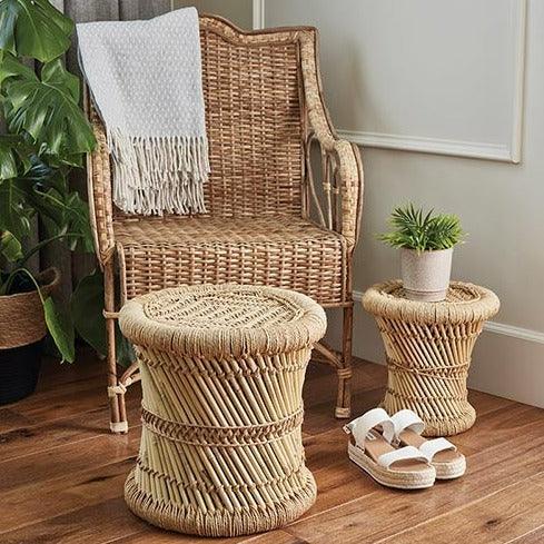 a wicker chair and foot stool on a wooden floor