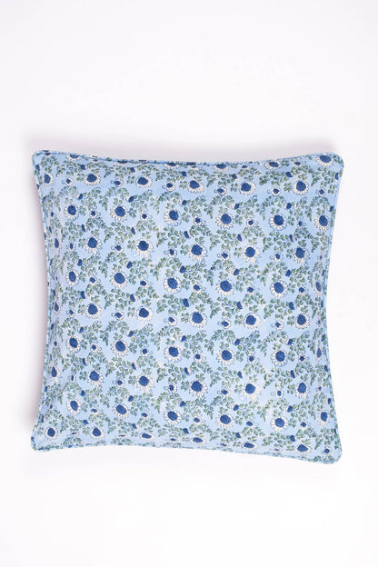 	Parijat Ocean Blue square pillow cover styled with an insert, featuring blue-and-white flowers and green vines