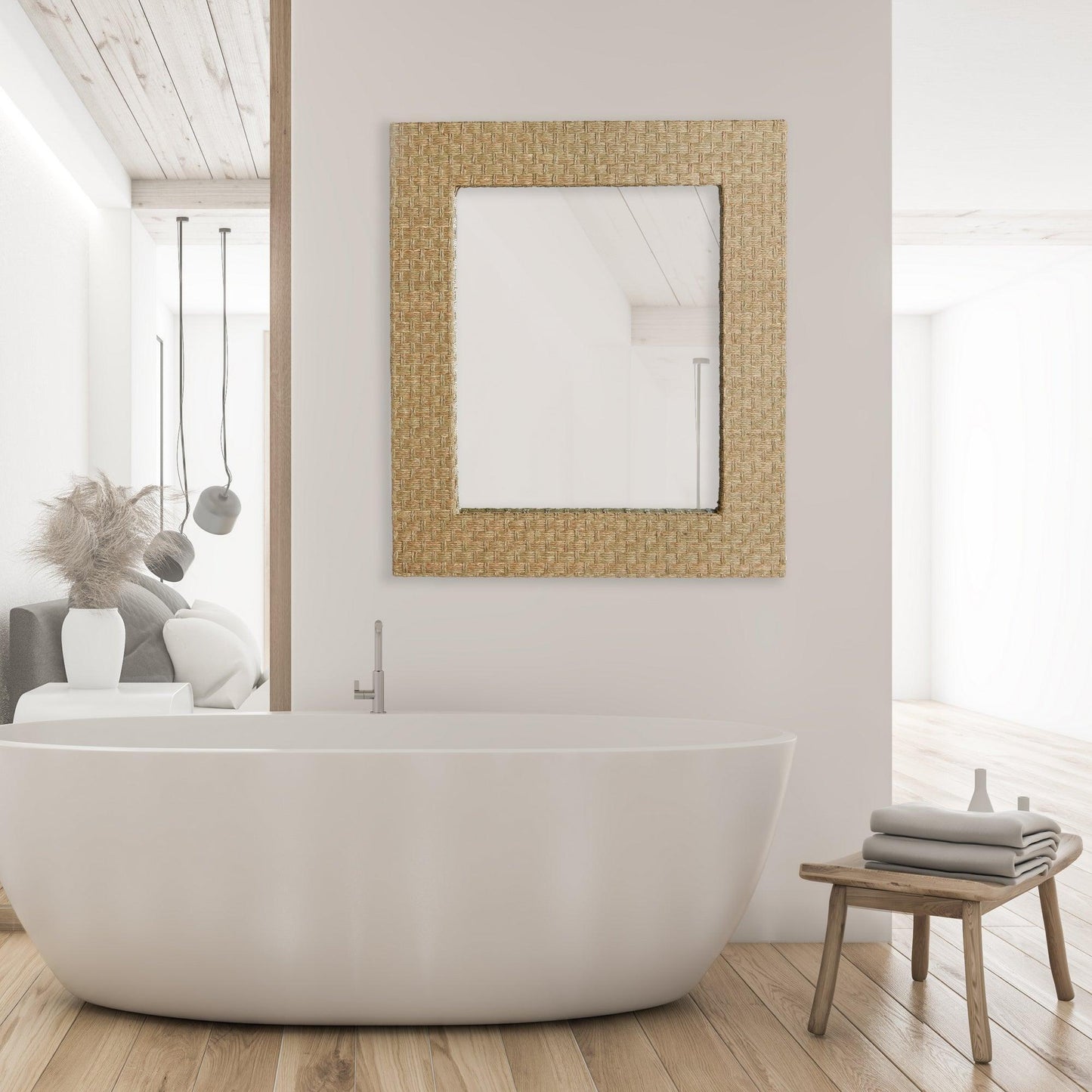 A bathroom with a woven mirror and white bath tub 