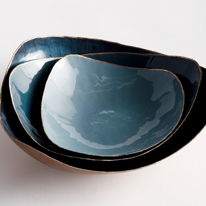 Three shiny blue bowls nested 