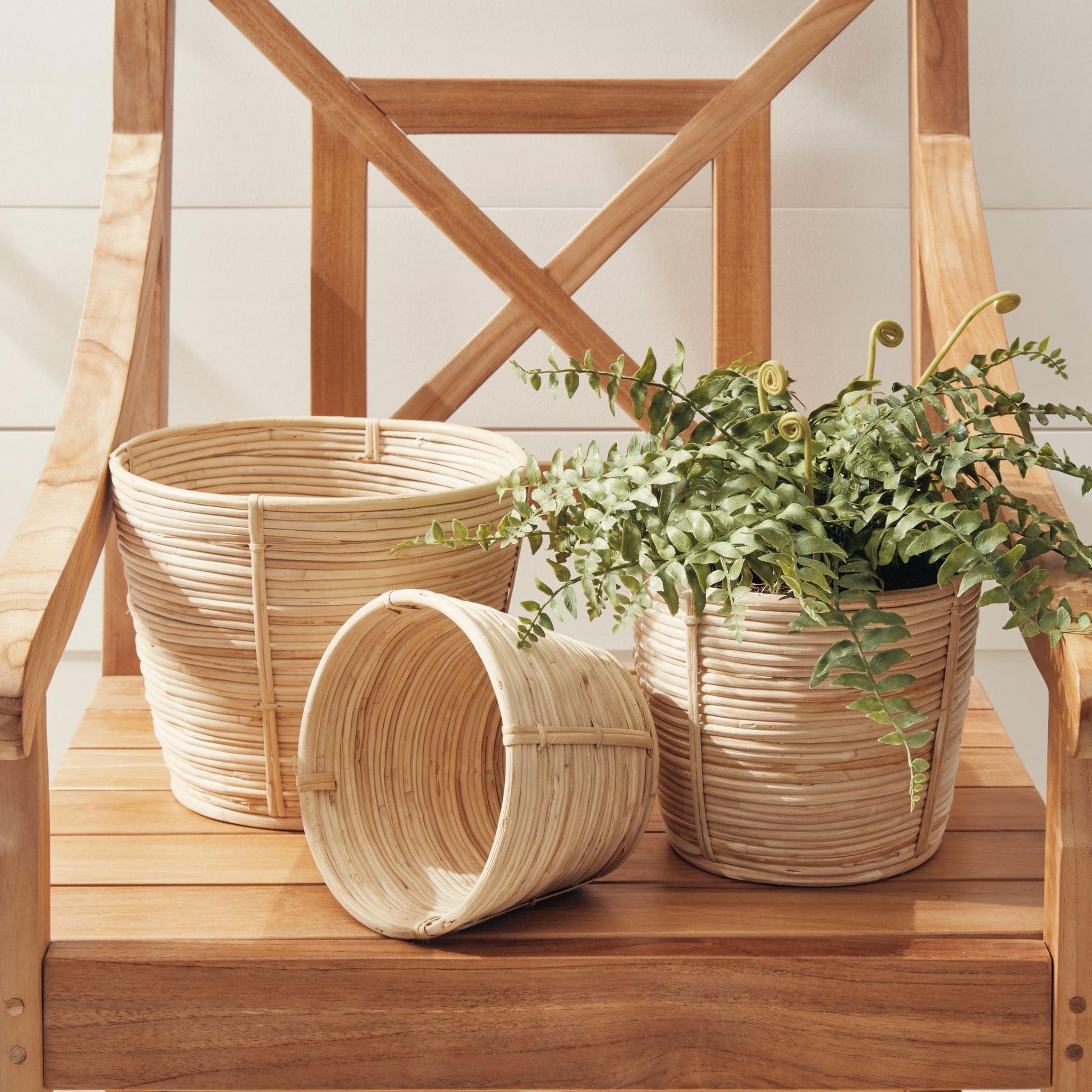 Three wicker baskets on a wood chair 