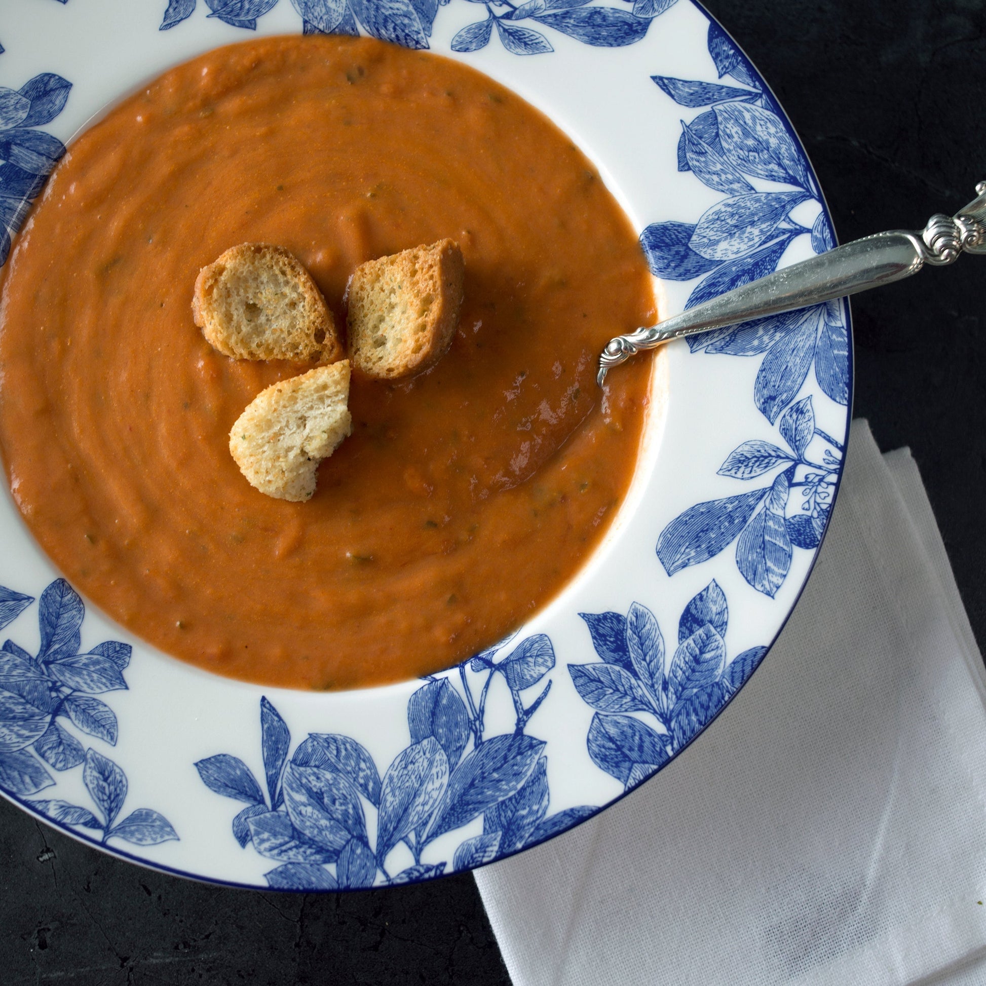 tomato soup in a blue and white bowl