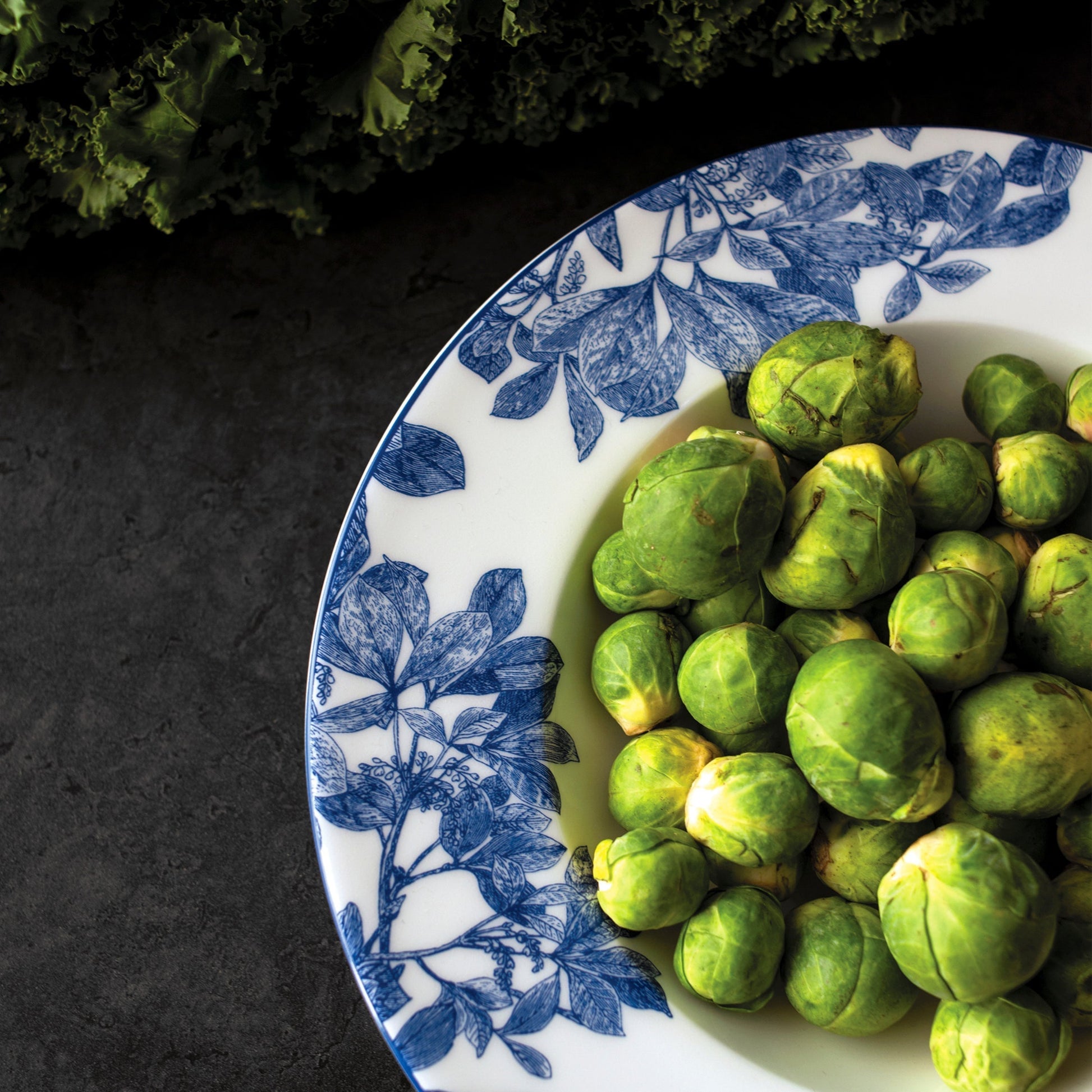 blue and white bowl filled with brussel sprouts