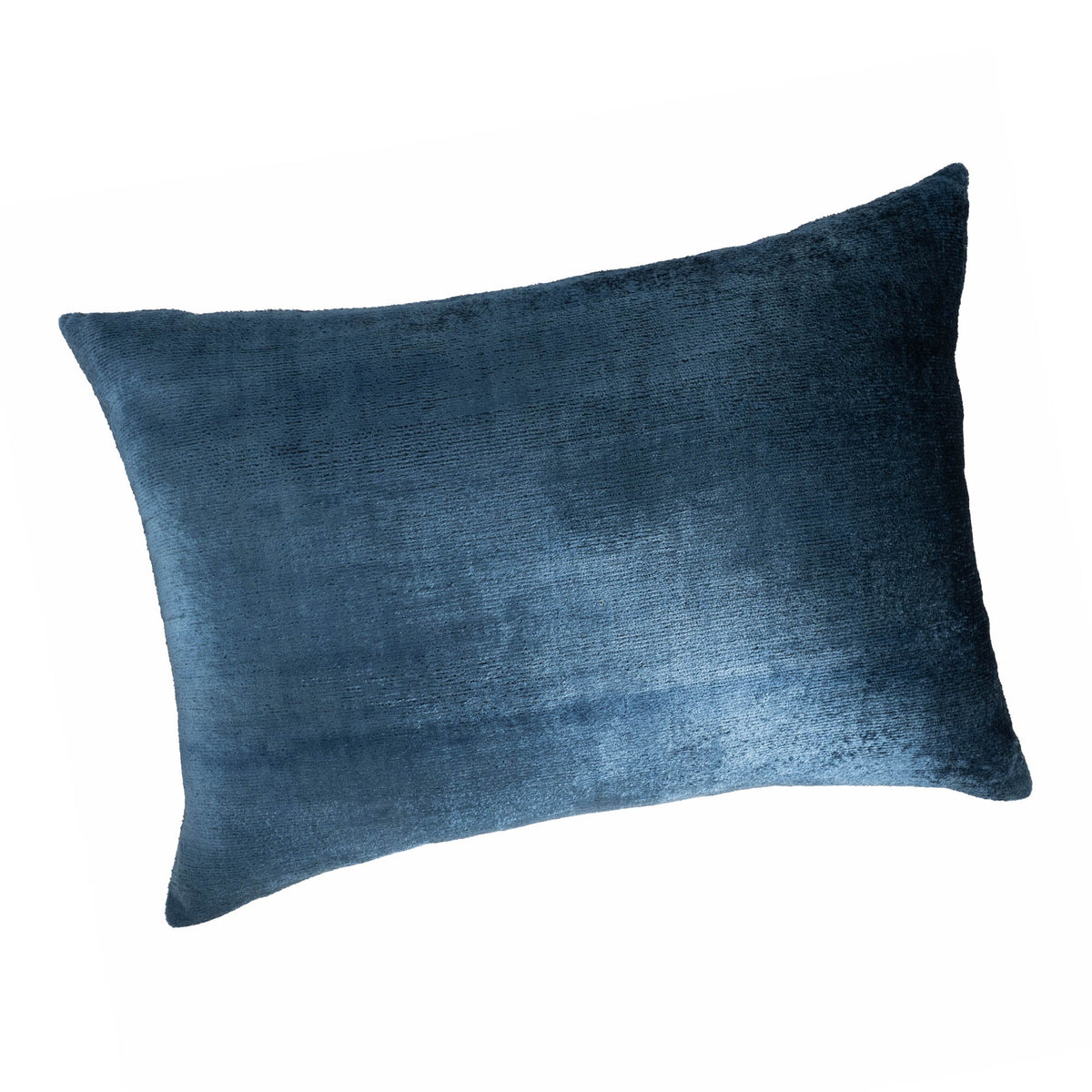 	Angled view of the Coastal Blue velvet pillow cover showing its sheen and rectangular shape