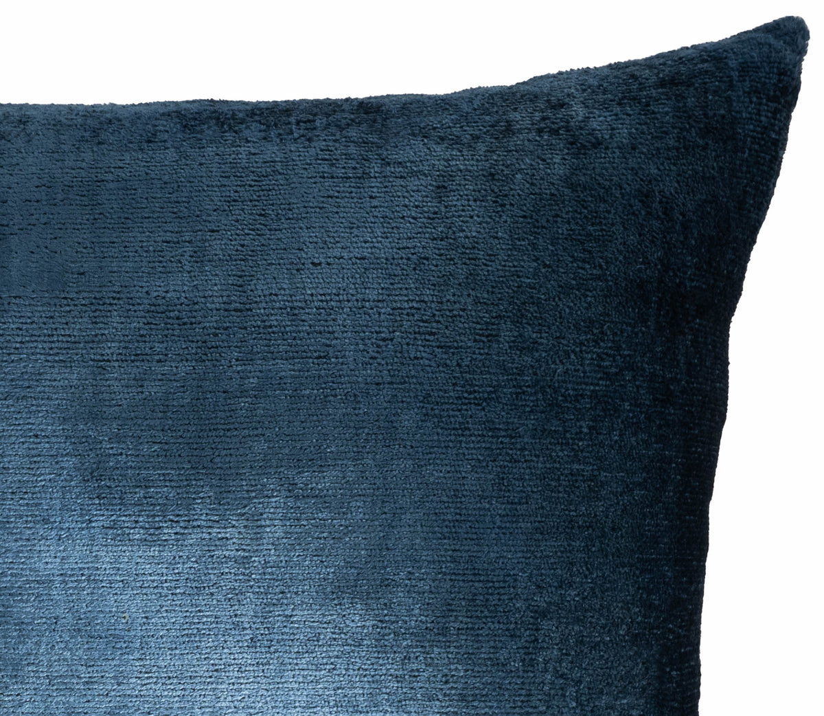 	Close-up of the blue silk velvet texture and upper corner of the pillow cover
