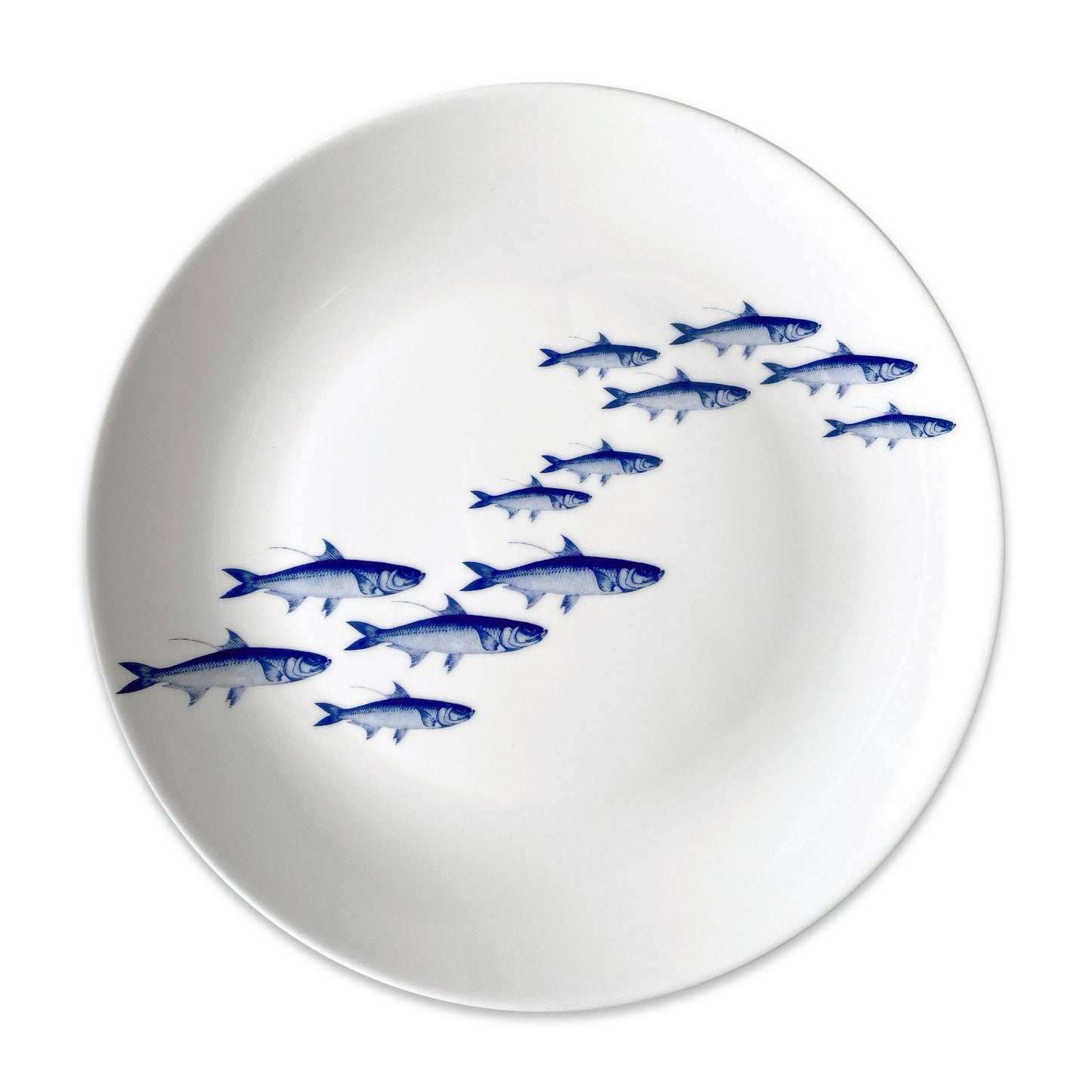 a white plate with blue fish on it