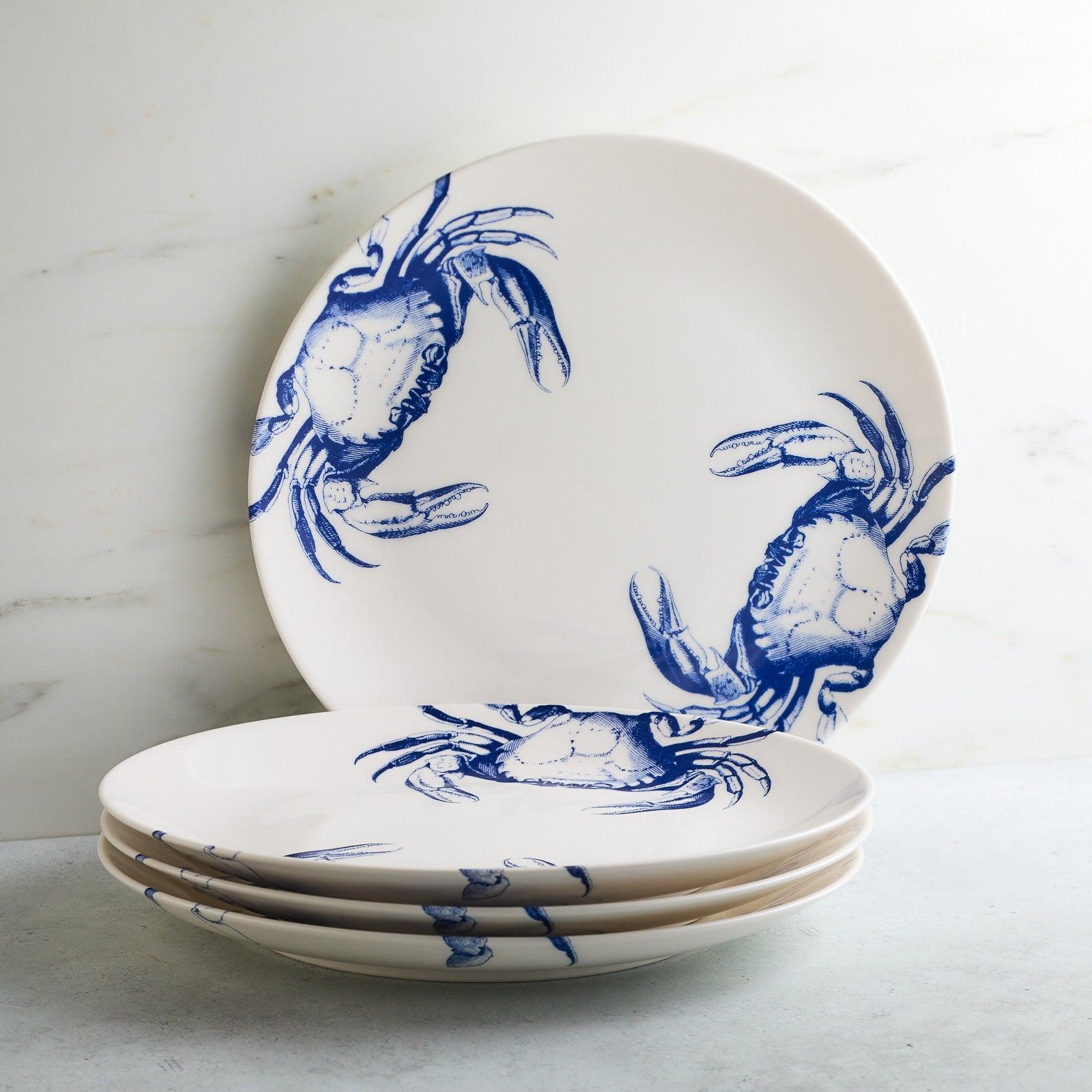 a stack of blue and white plates with crabs on them