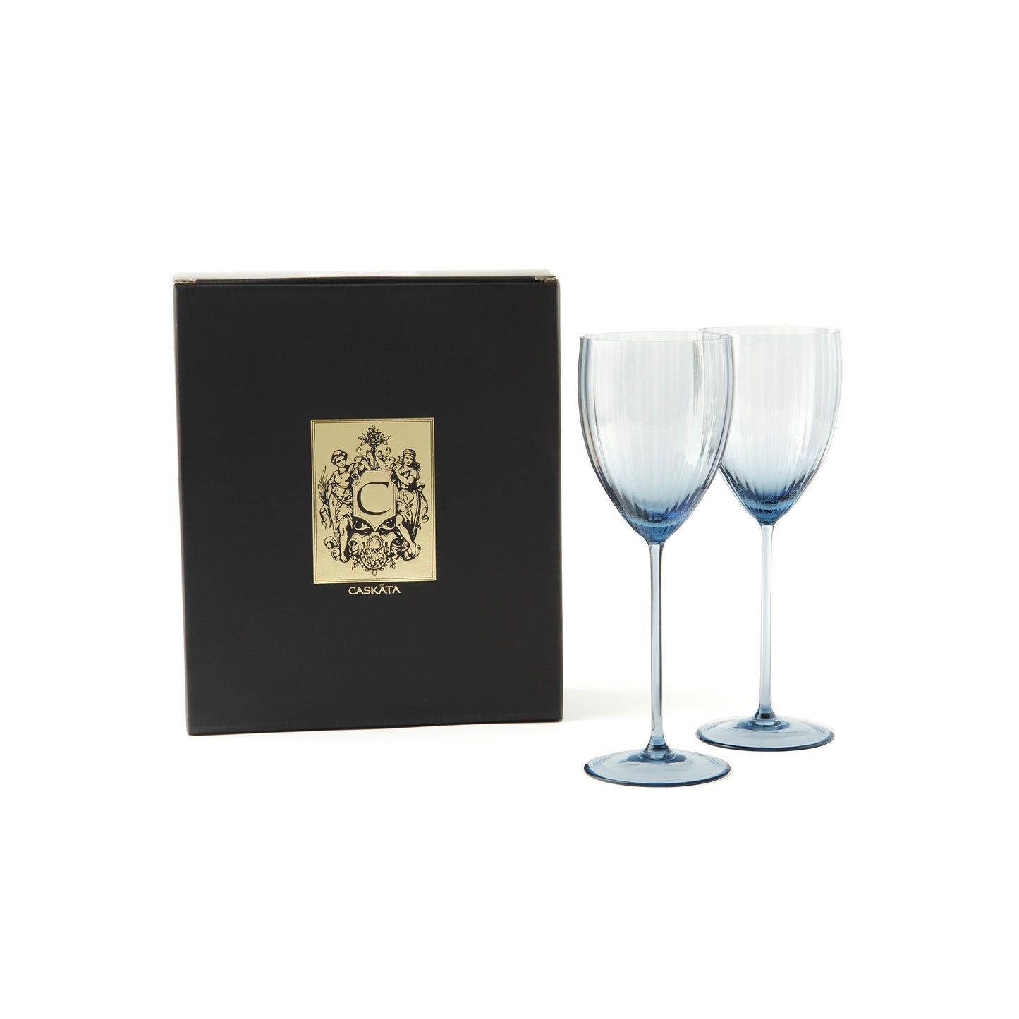 two blue wine glasses next to a black box