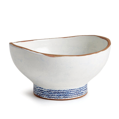 a white and blue bowl with a brown rim