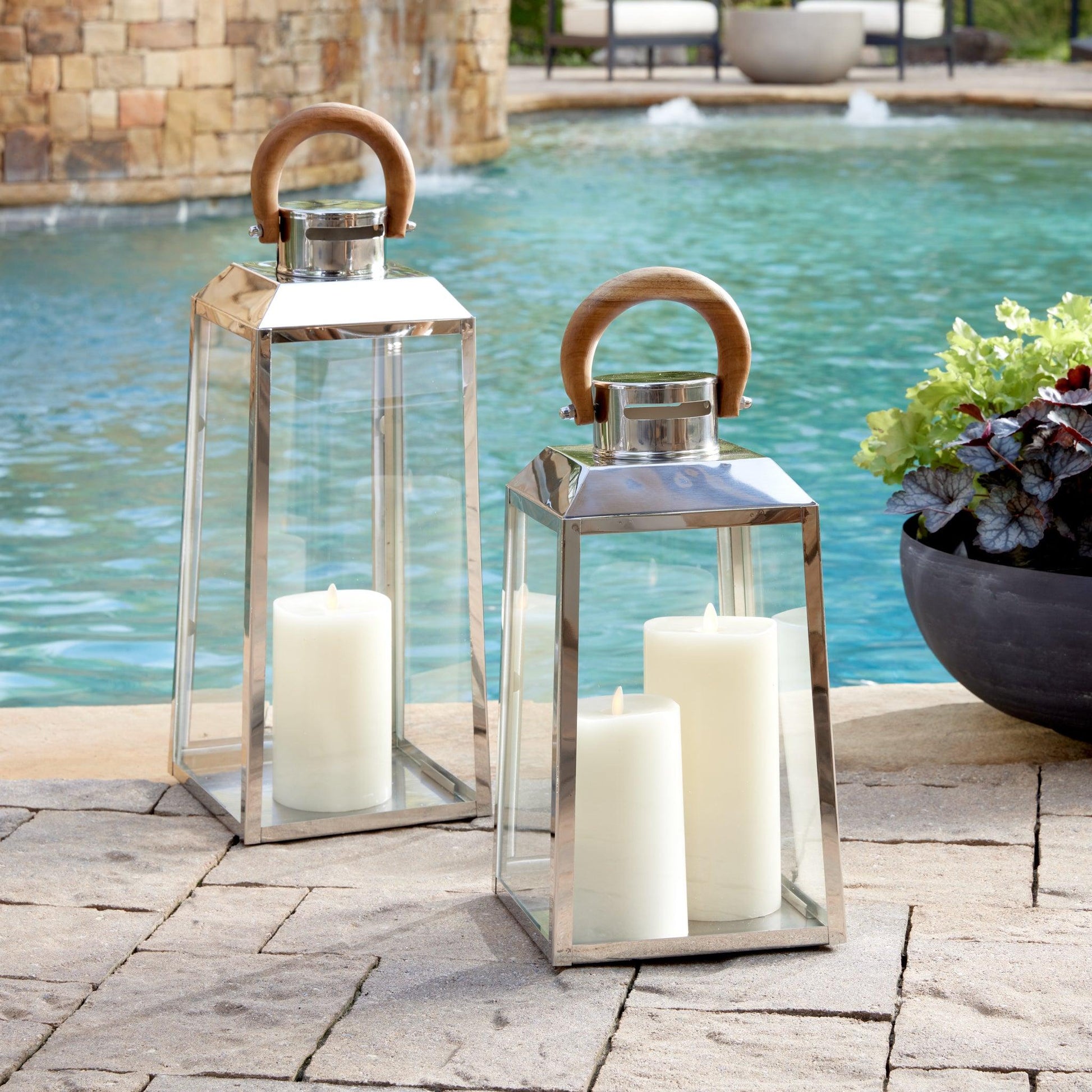 a couple of lanterns sitting next to a pool