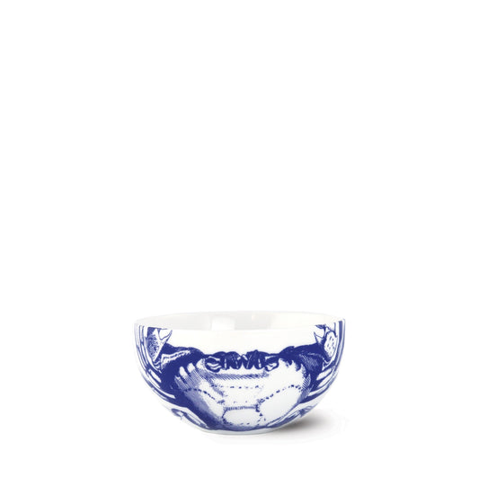 a blue and white bowl sitting on top of a table