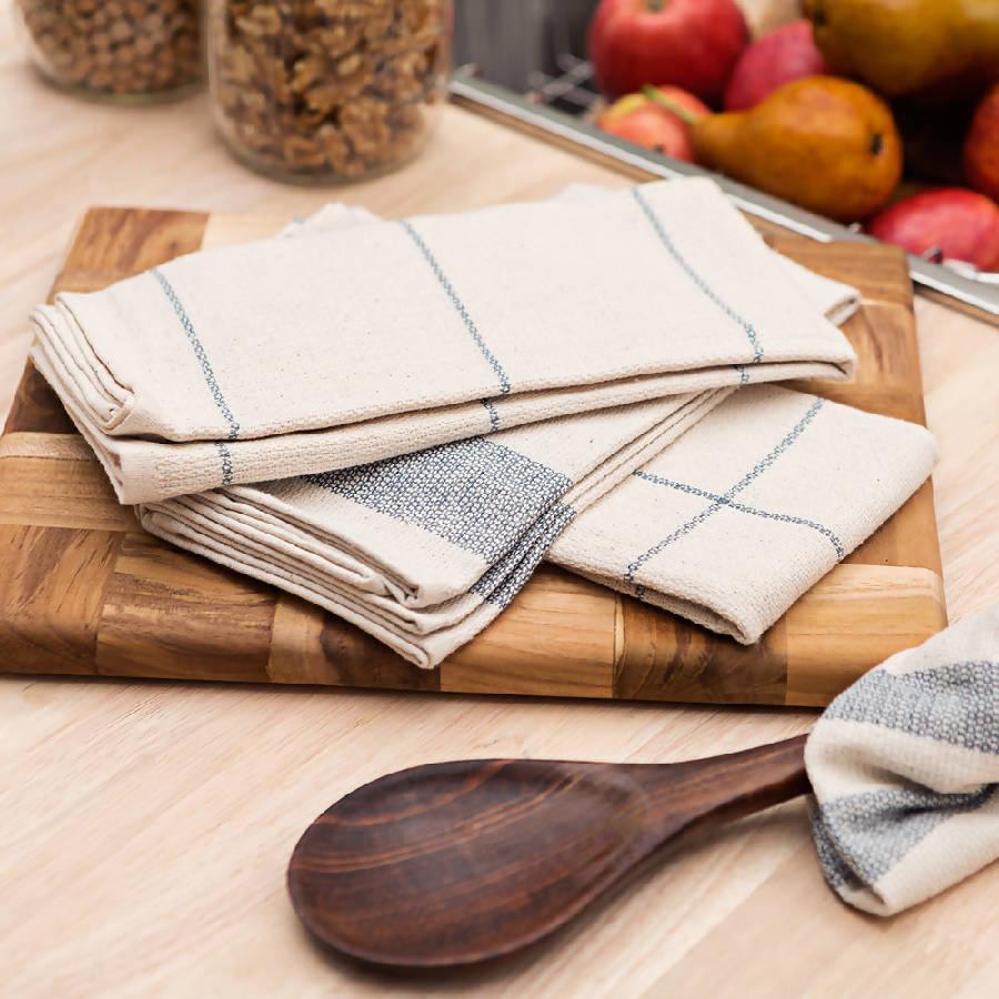 a wooden cutting board topped with napkins and a wooden spoon