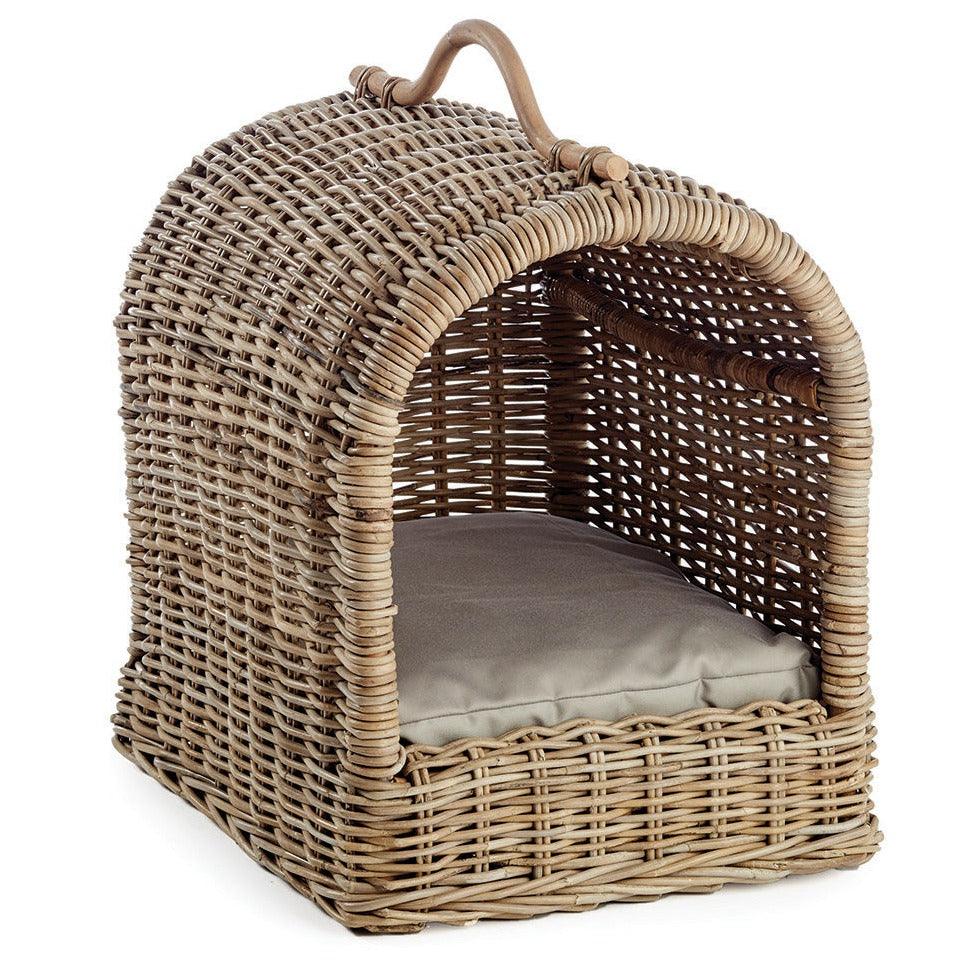 a wicker dog bed with a cushion