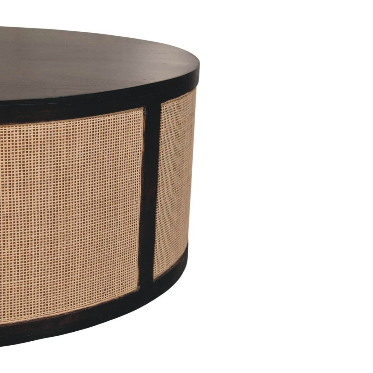 	Close-up of the Monaco table’s curved edge, dark wood frame, and woven rattan panel