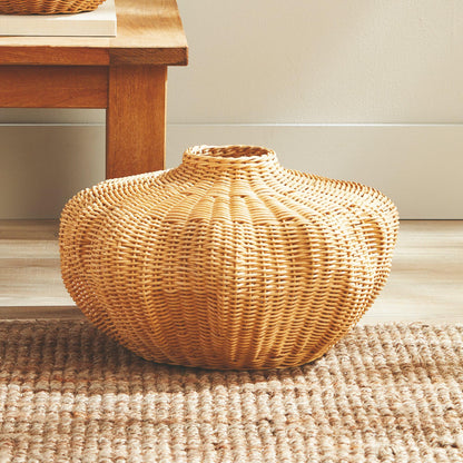 Wicker vase on woven carpet 