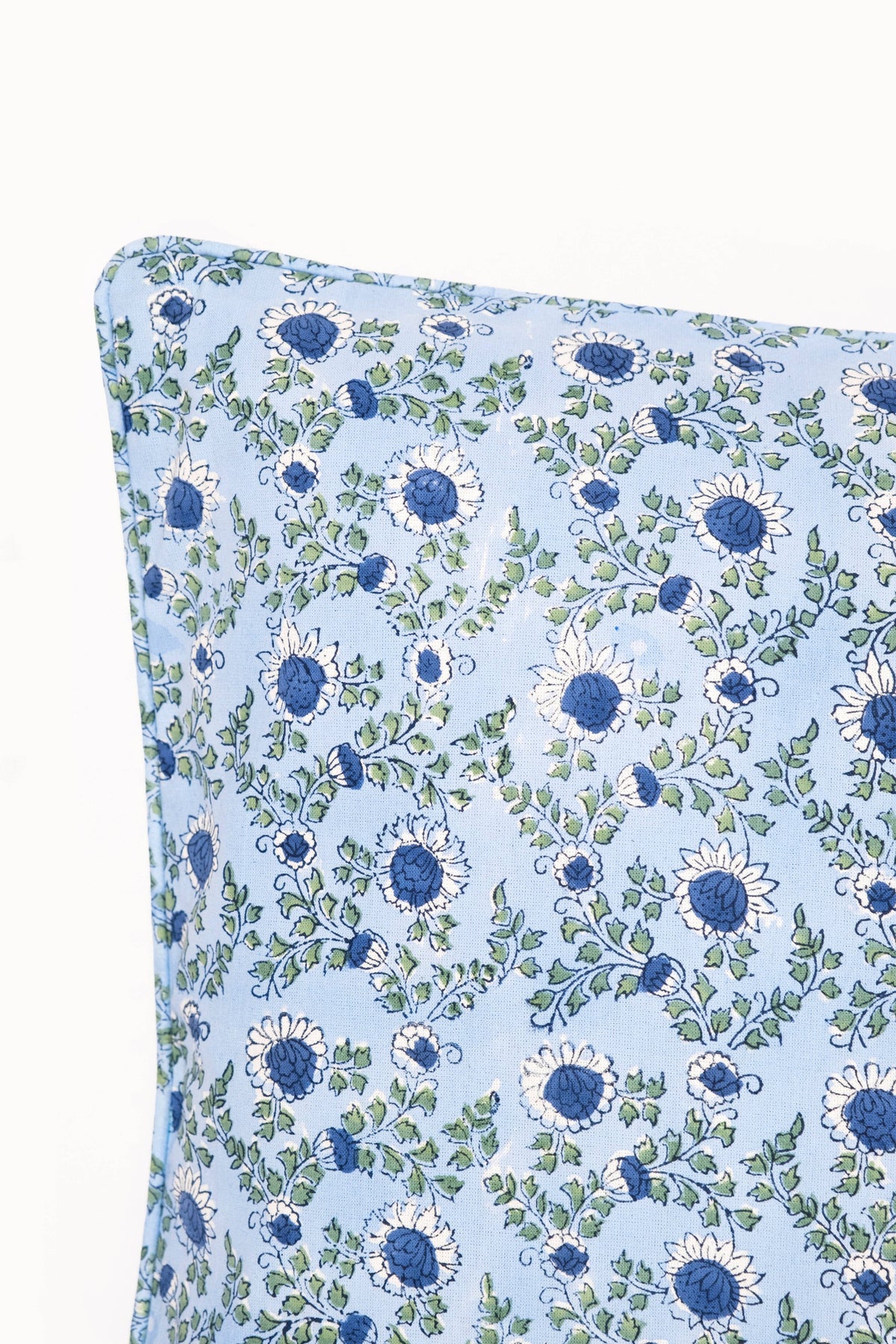 	Close-up of the Parijat Ocean Blue cotton pillow cover showing the floral block print and piped corner