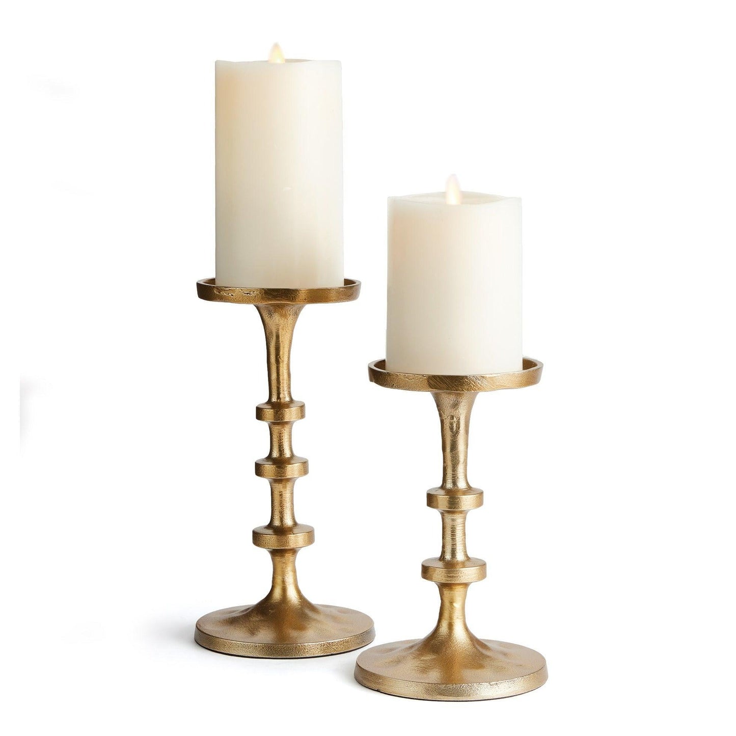 two gold candle stands with pillar candles