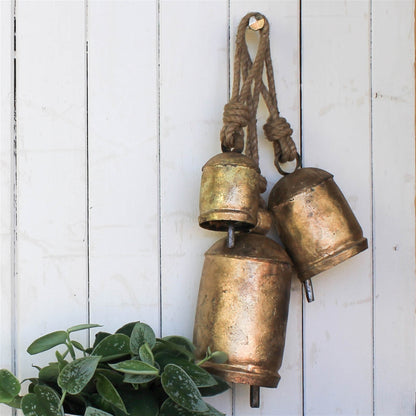 three gold bells on ropes