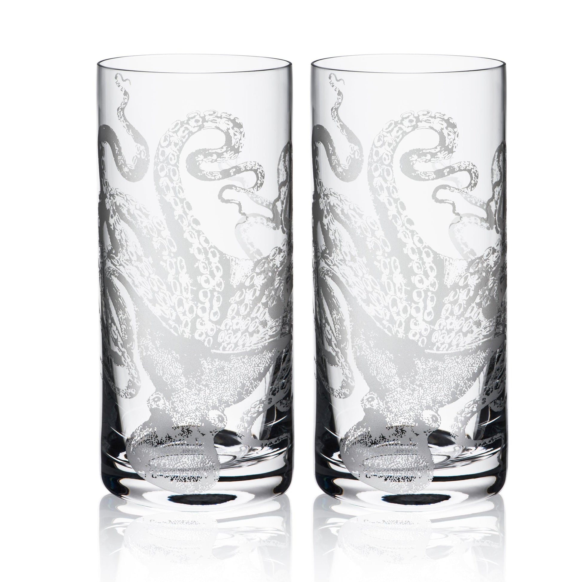 a couple of highball glasses sitting next to each other