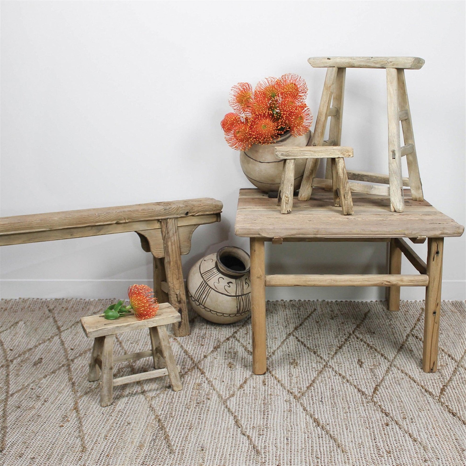 Group of rustic wood benches on a carpet 