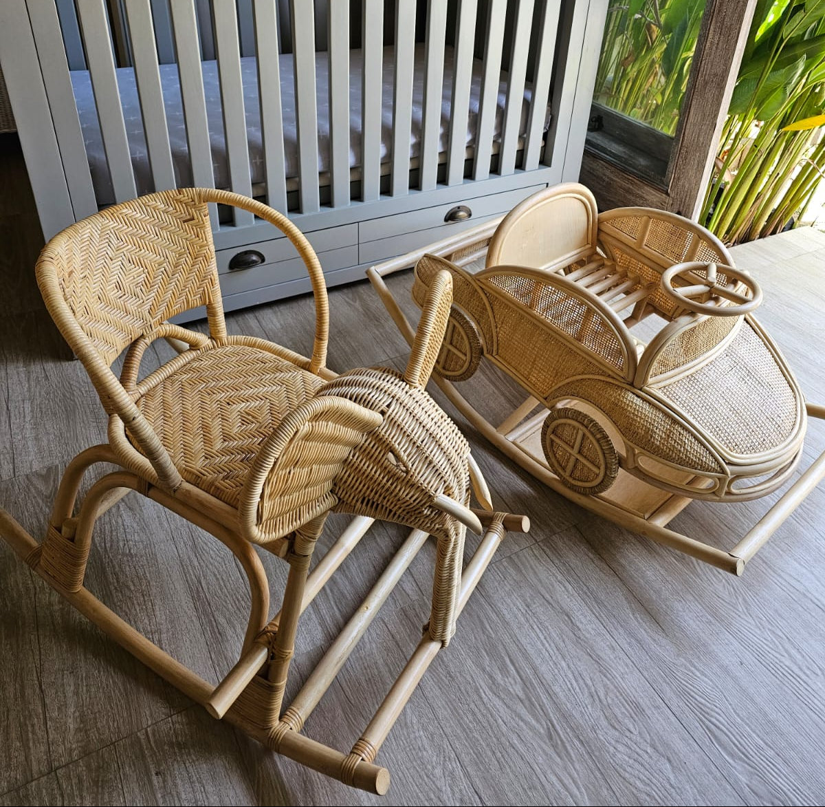 Rattan rocking car beside a woven rocking chair near a crib