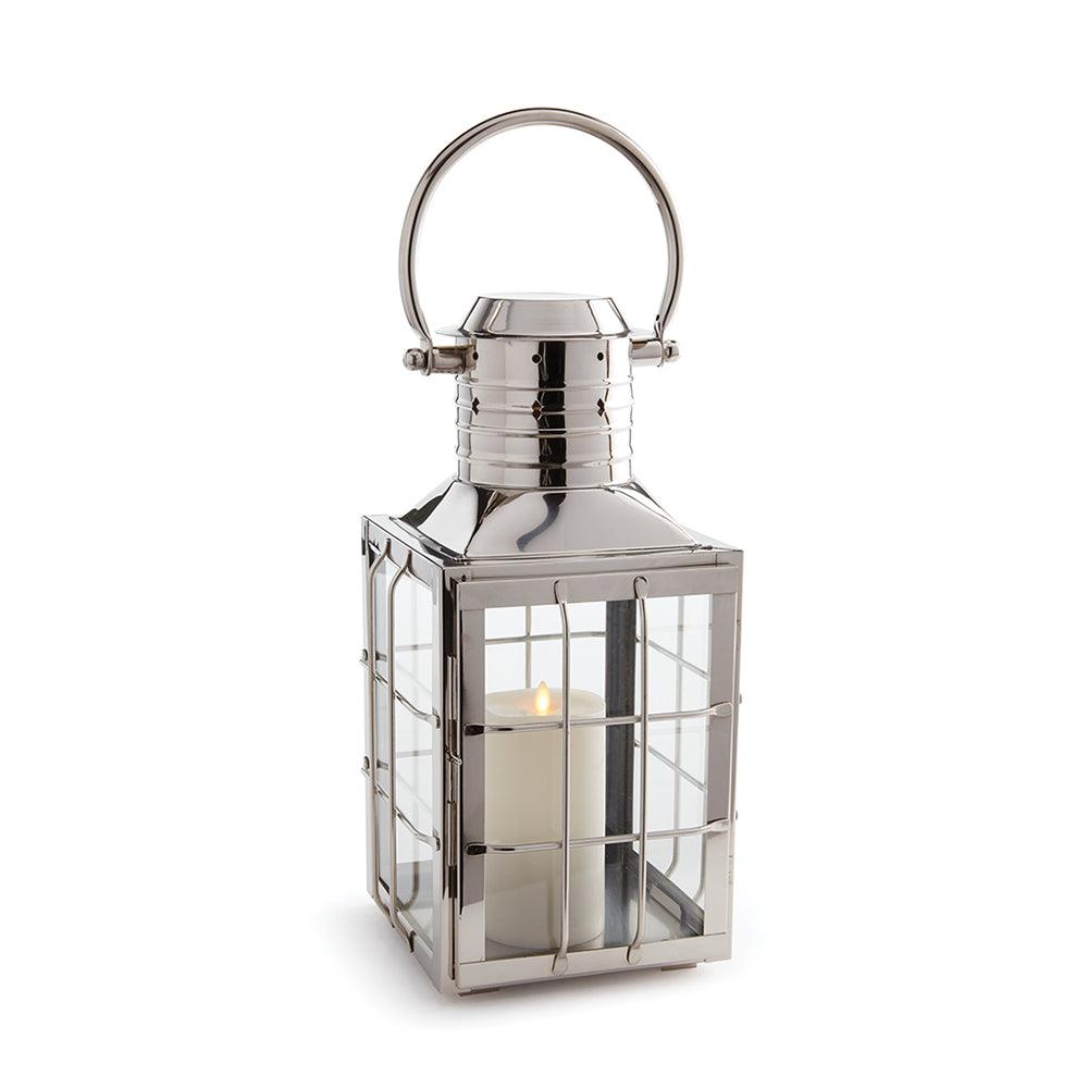 a metal lantern with a candle inside of it