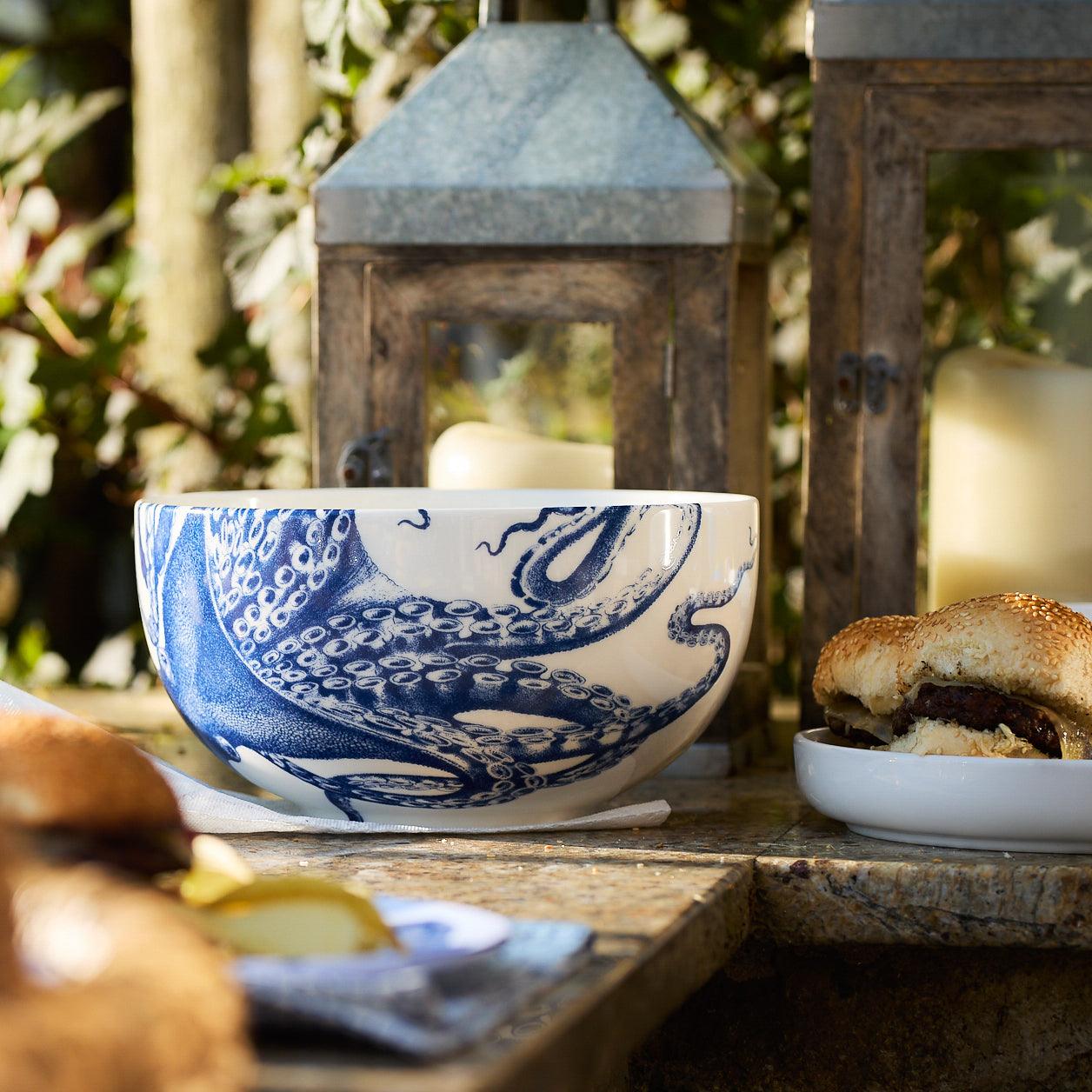 a blue and white bowl with a sandwich in it