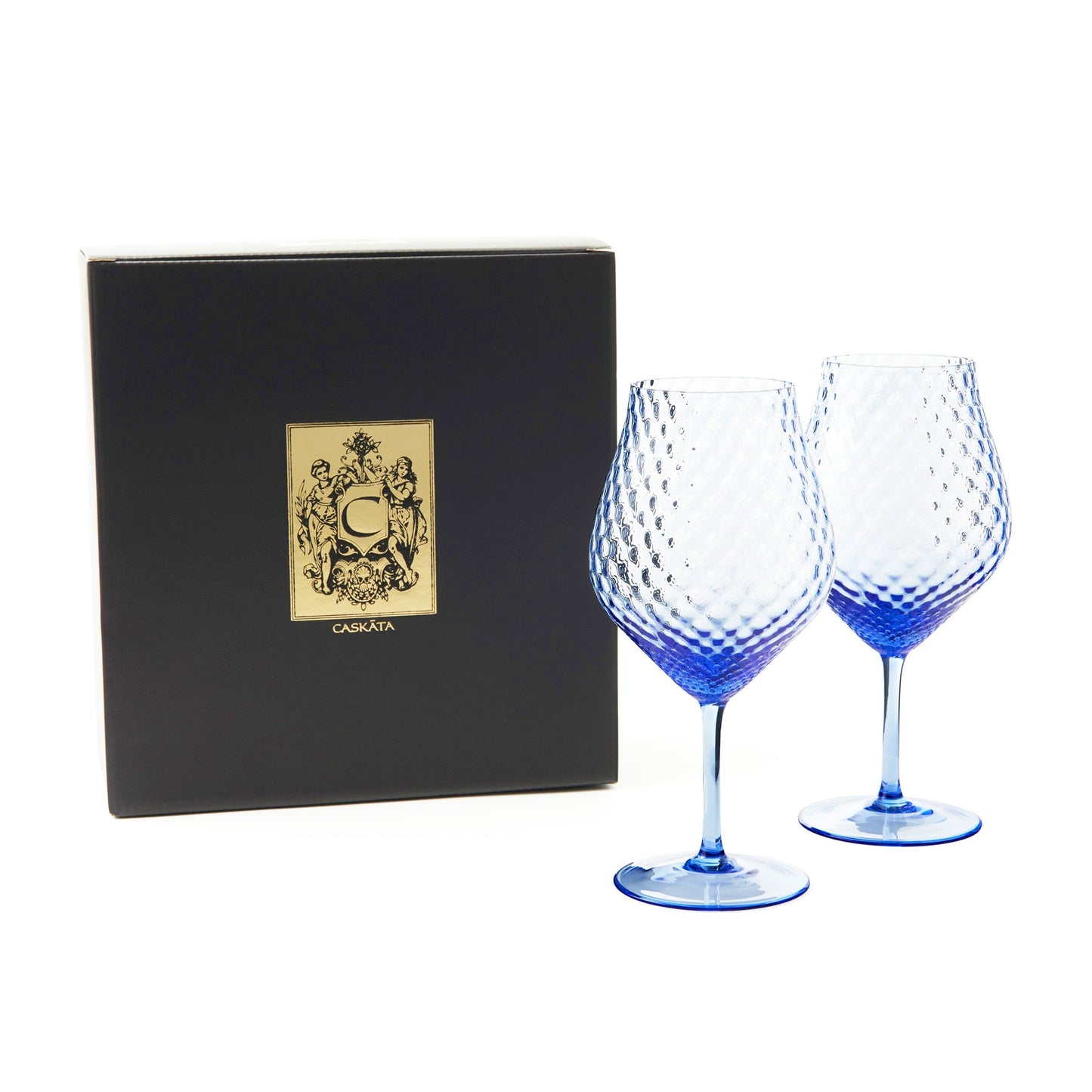 two large blue wine glasses next to a black box