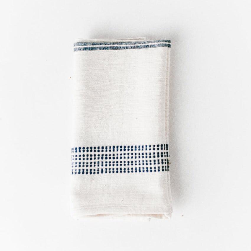 a white napkin with a blue stripe on it