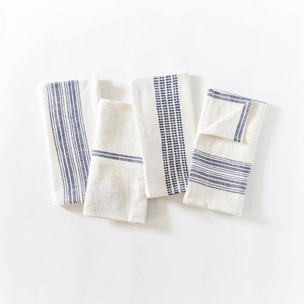 a group of four napkins sitting on top of a white table