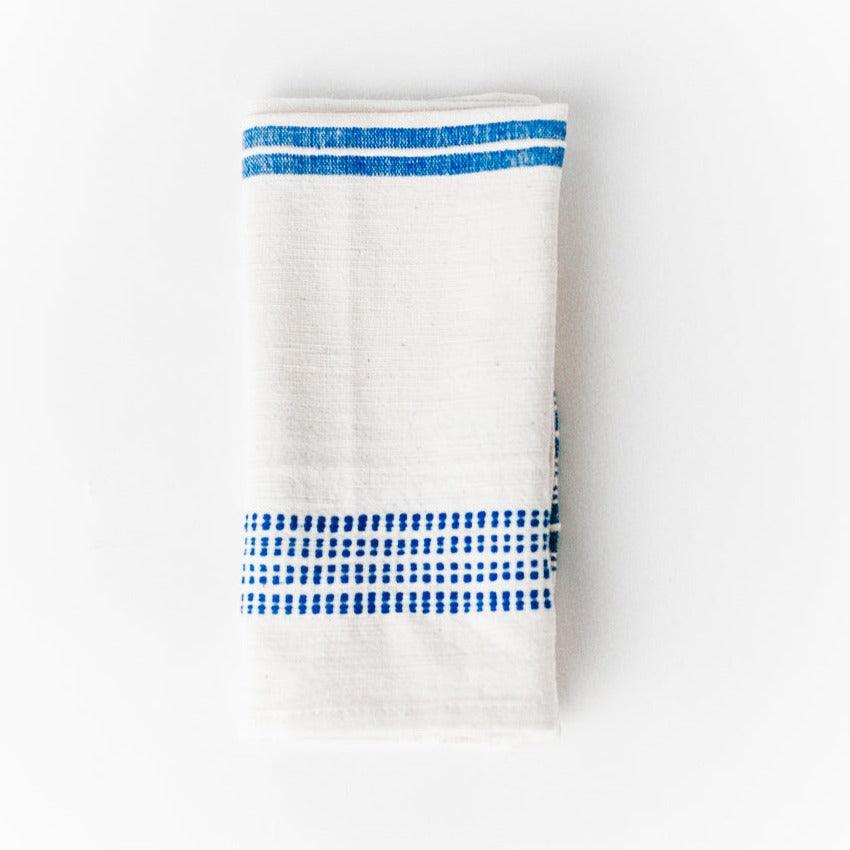 a white napkin with a blue stripe on it