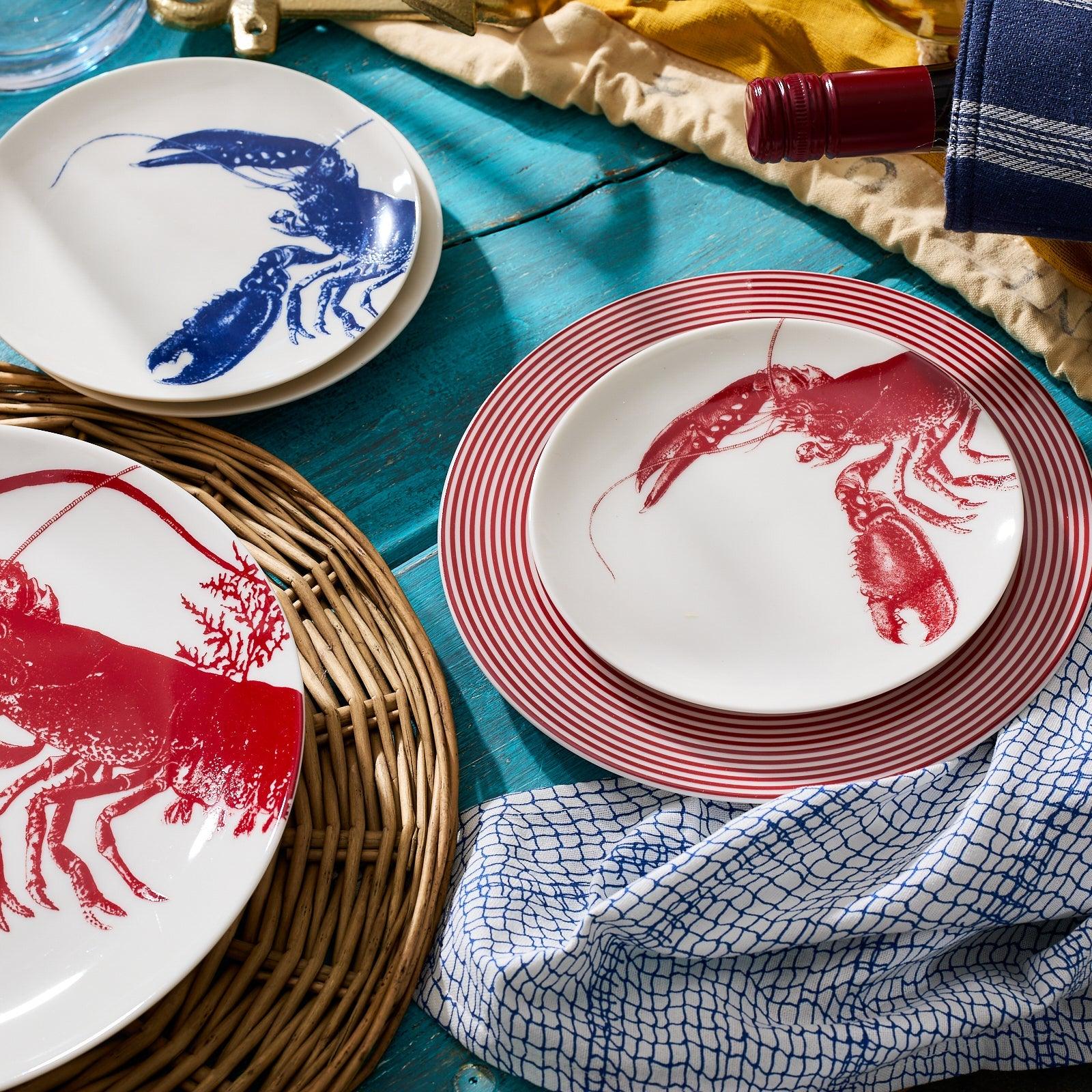 a table topped with plates covered in red and blue designs