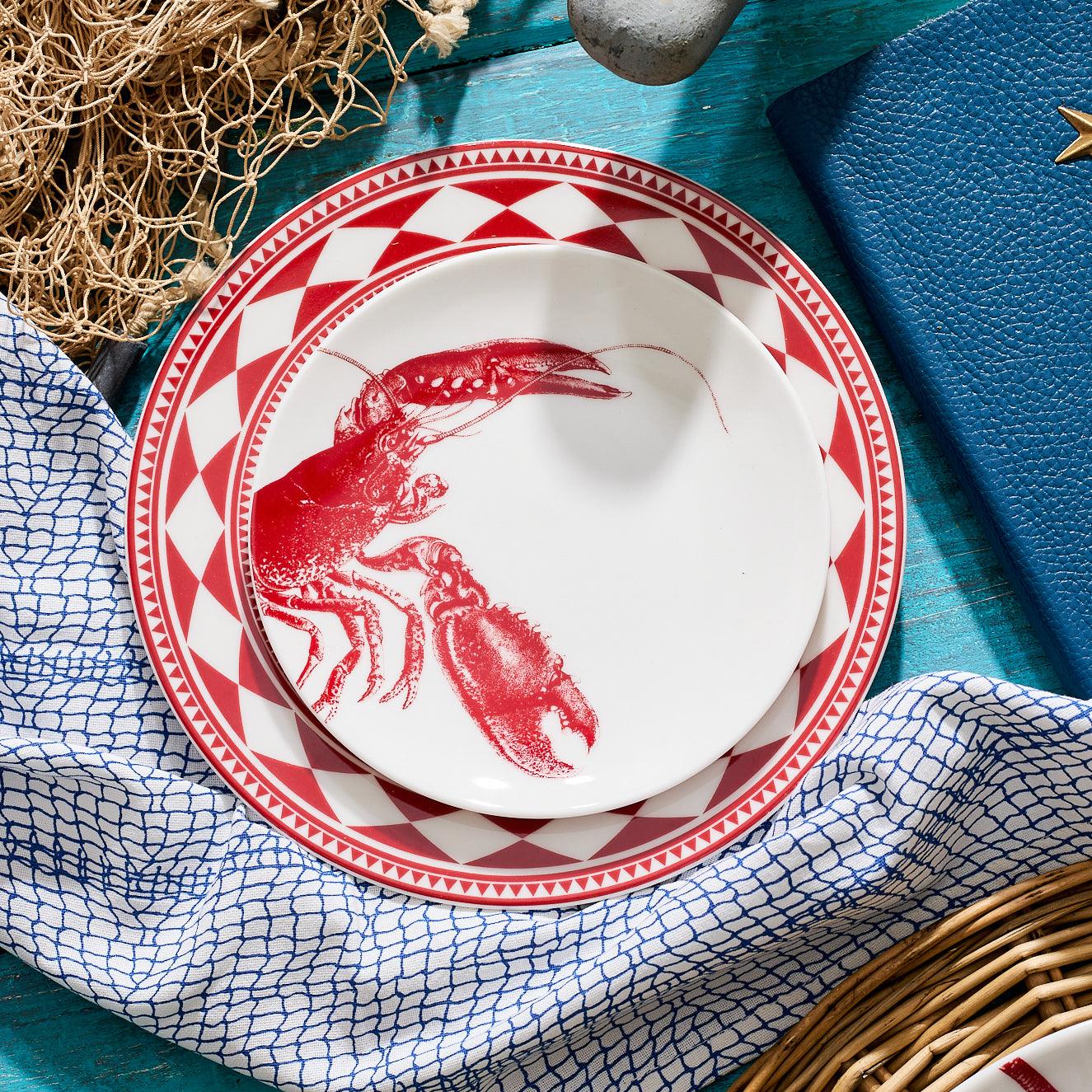 a red and white plate with a picture of a lobster on it