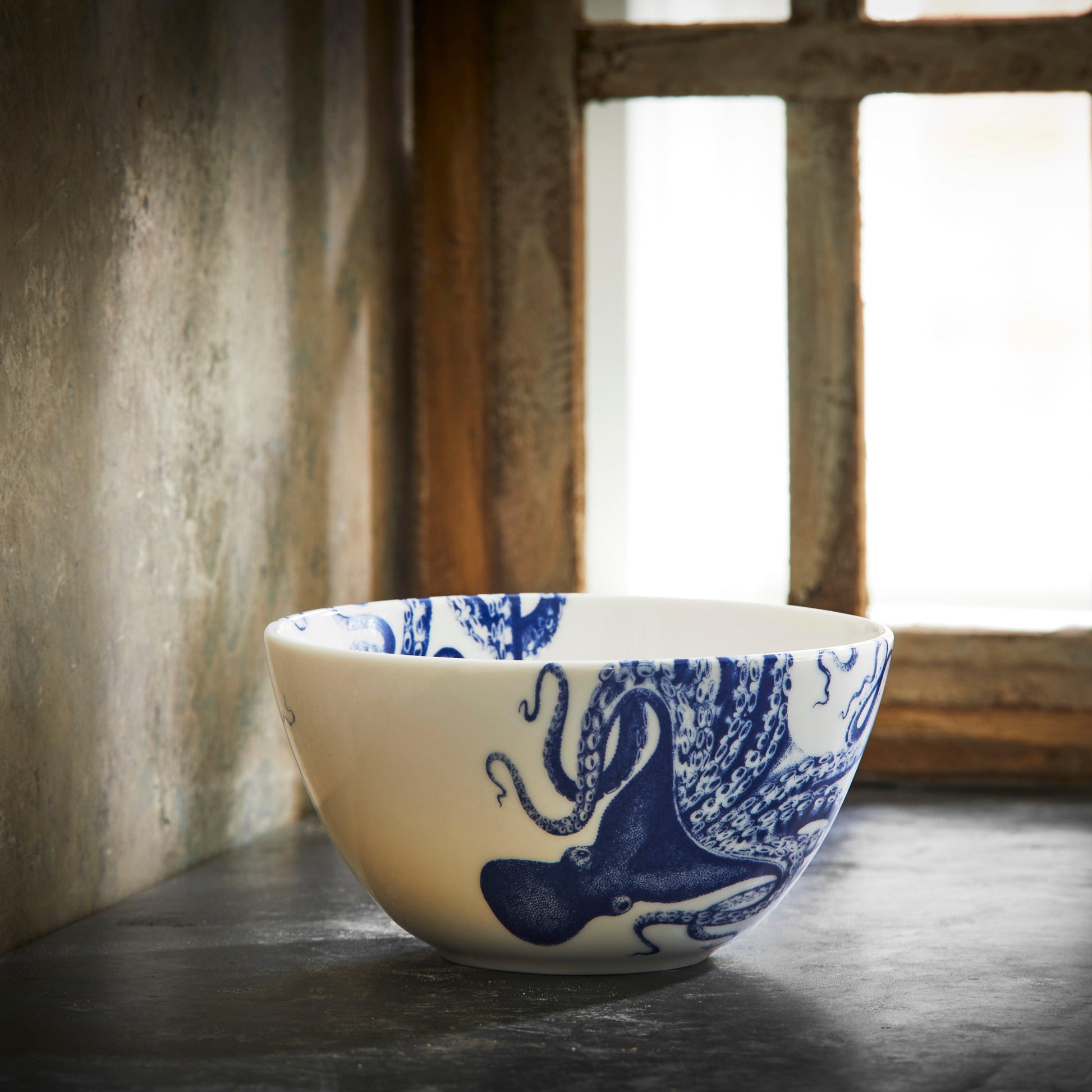 a blue and white bowl sitting on top of a counter