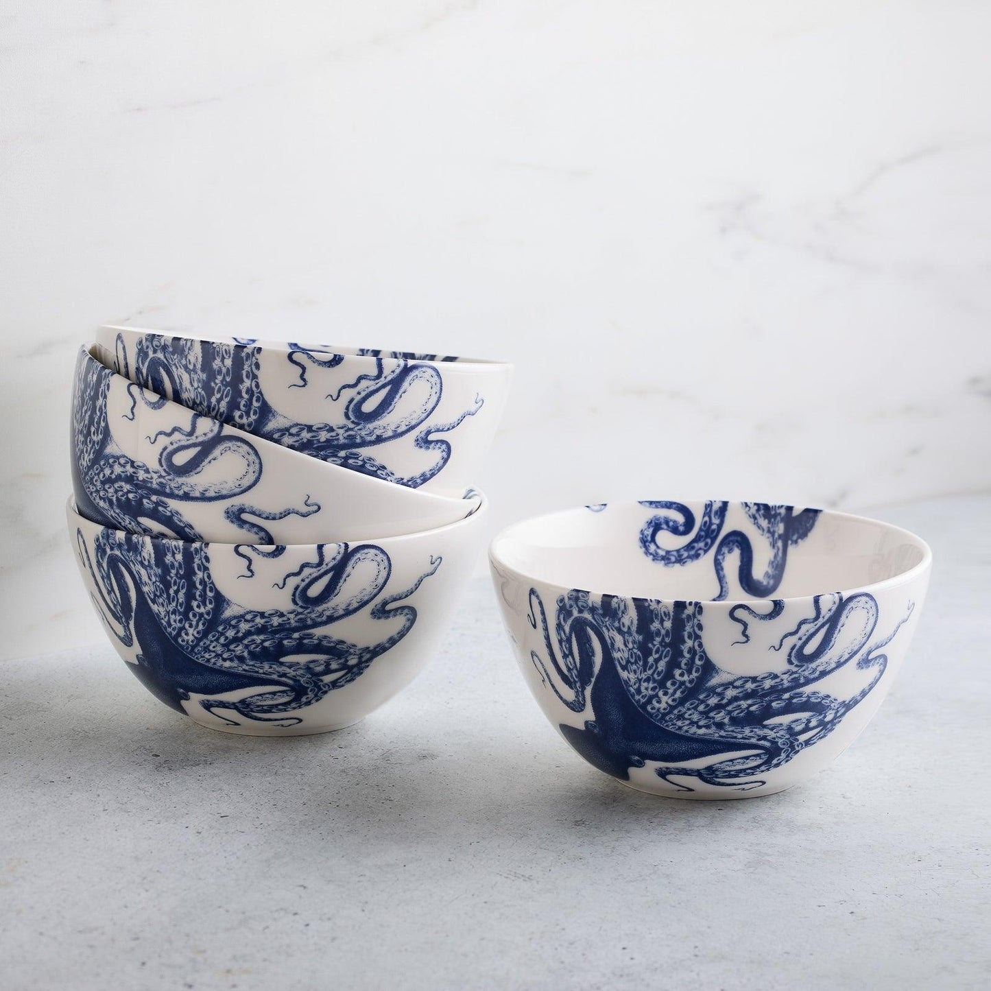 a set of four blue and white bowls