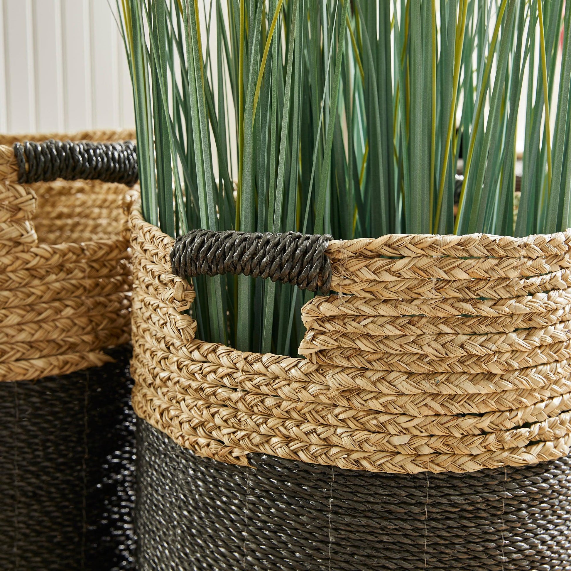 a close up of two baskets with grass in them