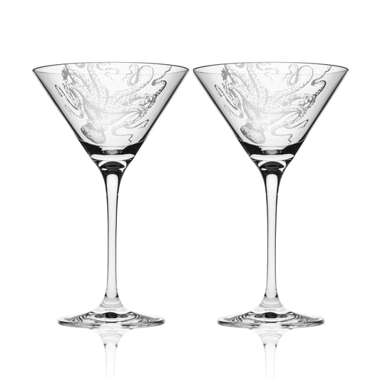 a pair of martini glasses sitting next to each other