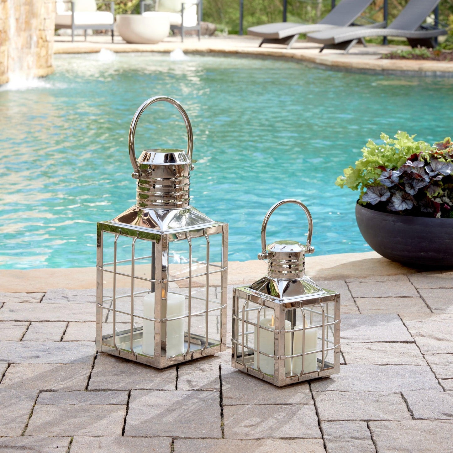 a couple of lanterns sitting next to a pool