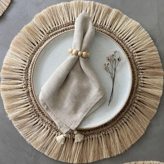 a plate with a napkin and a flower on it