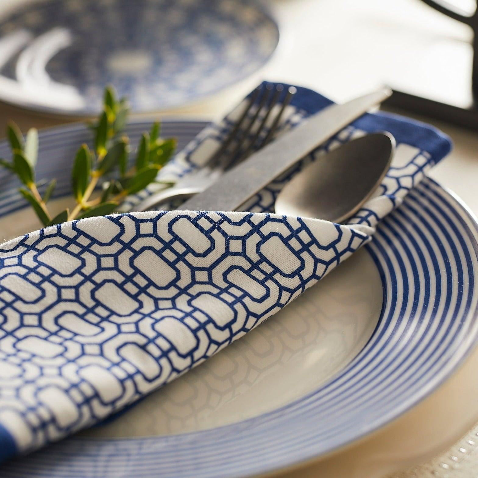 a blue and white plate with a fork and knife