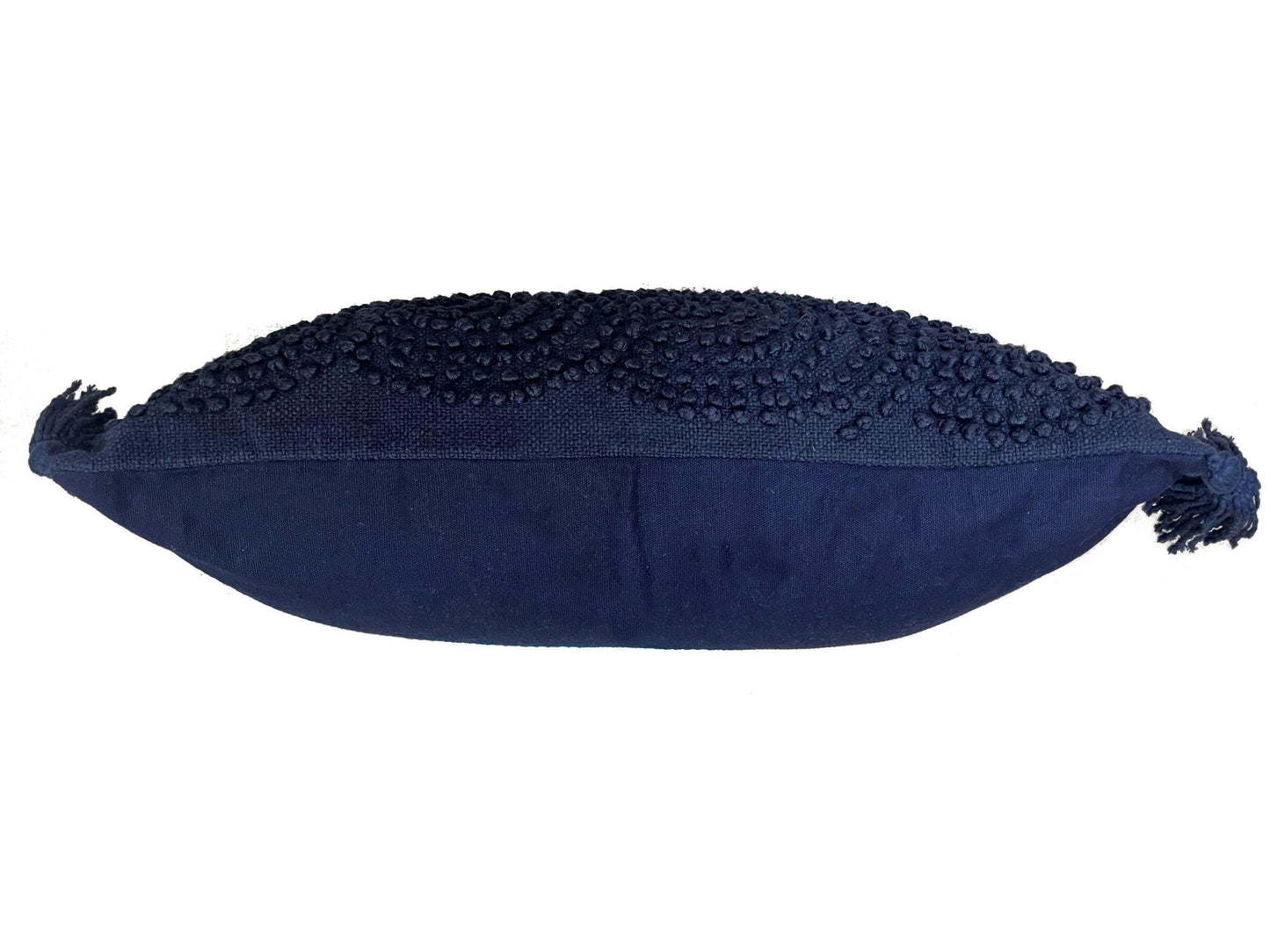 side view of dark blue pillow with tassels