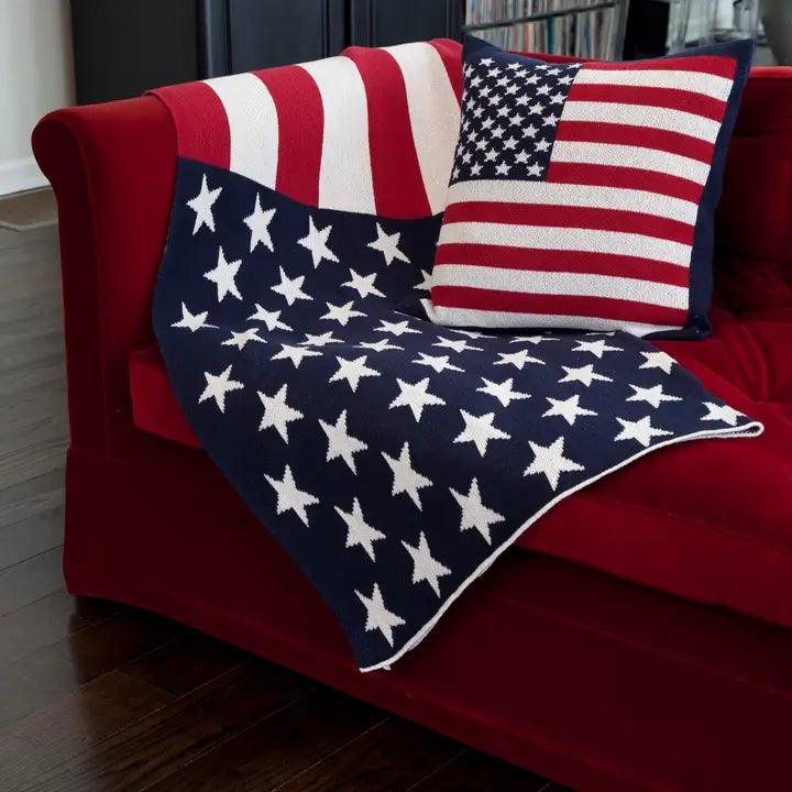 a red couch with american flag pillows on it