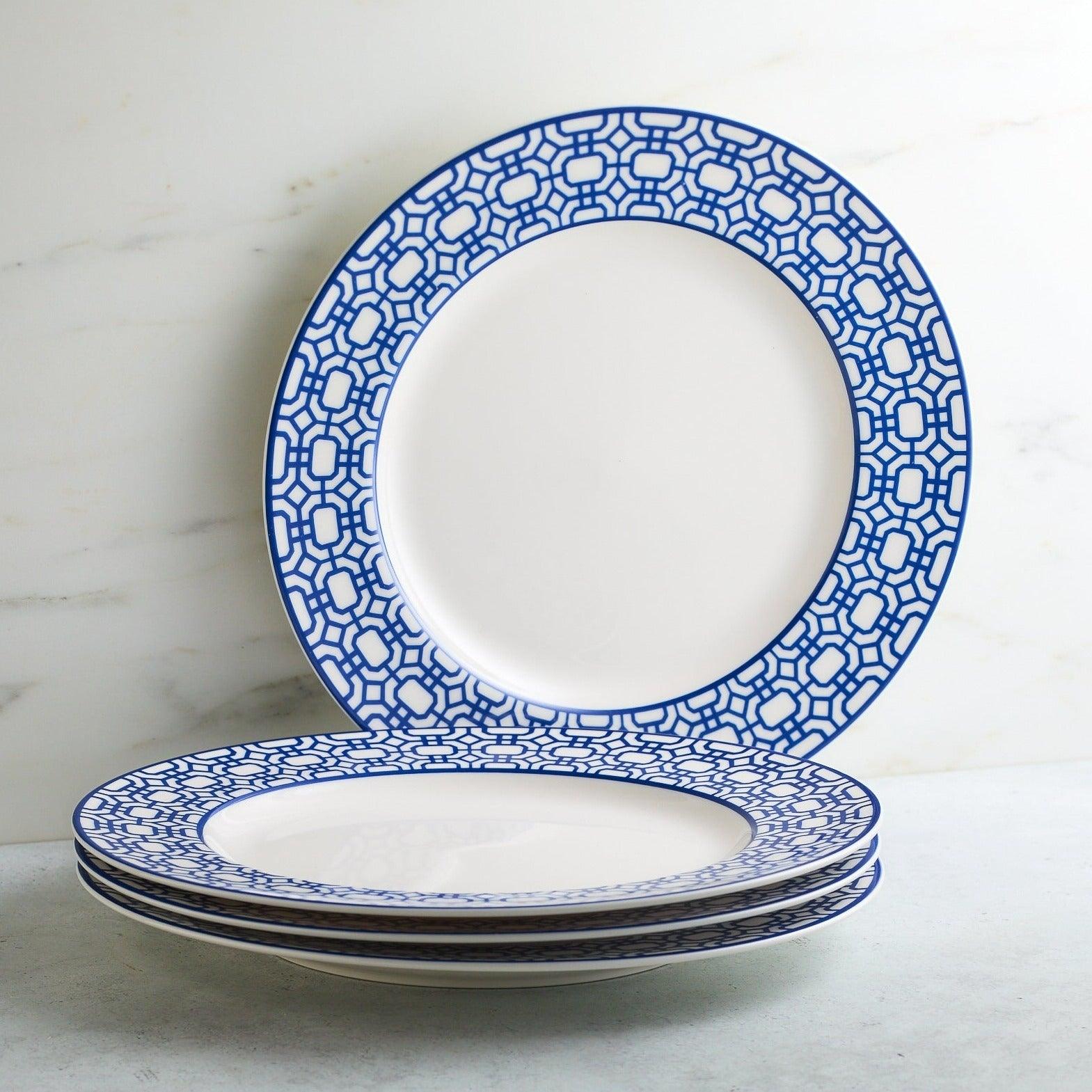 a set of four blue and white plates