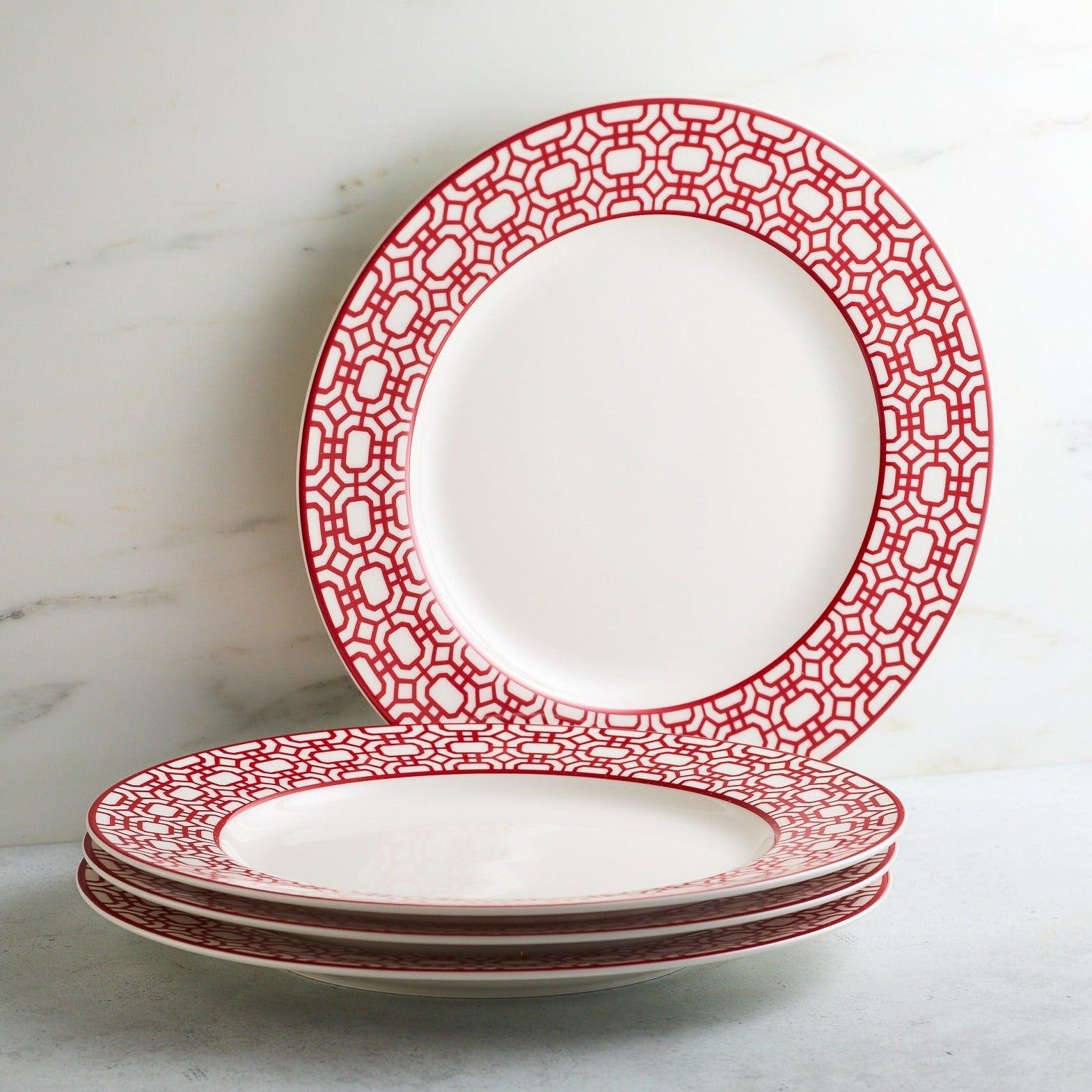 a stack of red and white plates sitting on top of a table