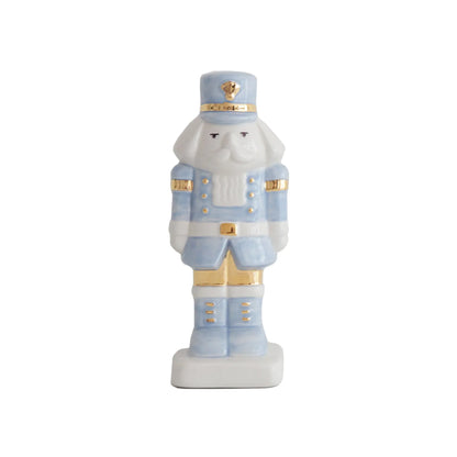 Light blue and white decorative Christmas nutcracker with gold accents on its hat, uniform, and boots