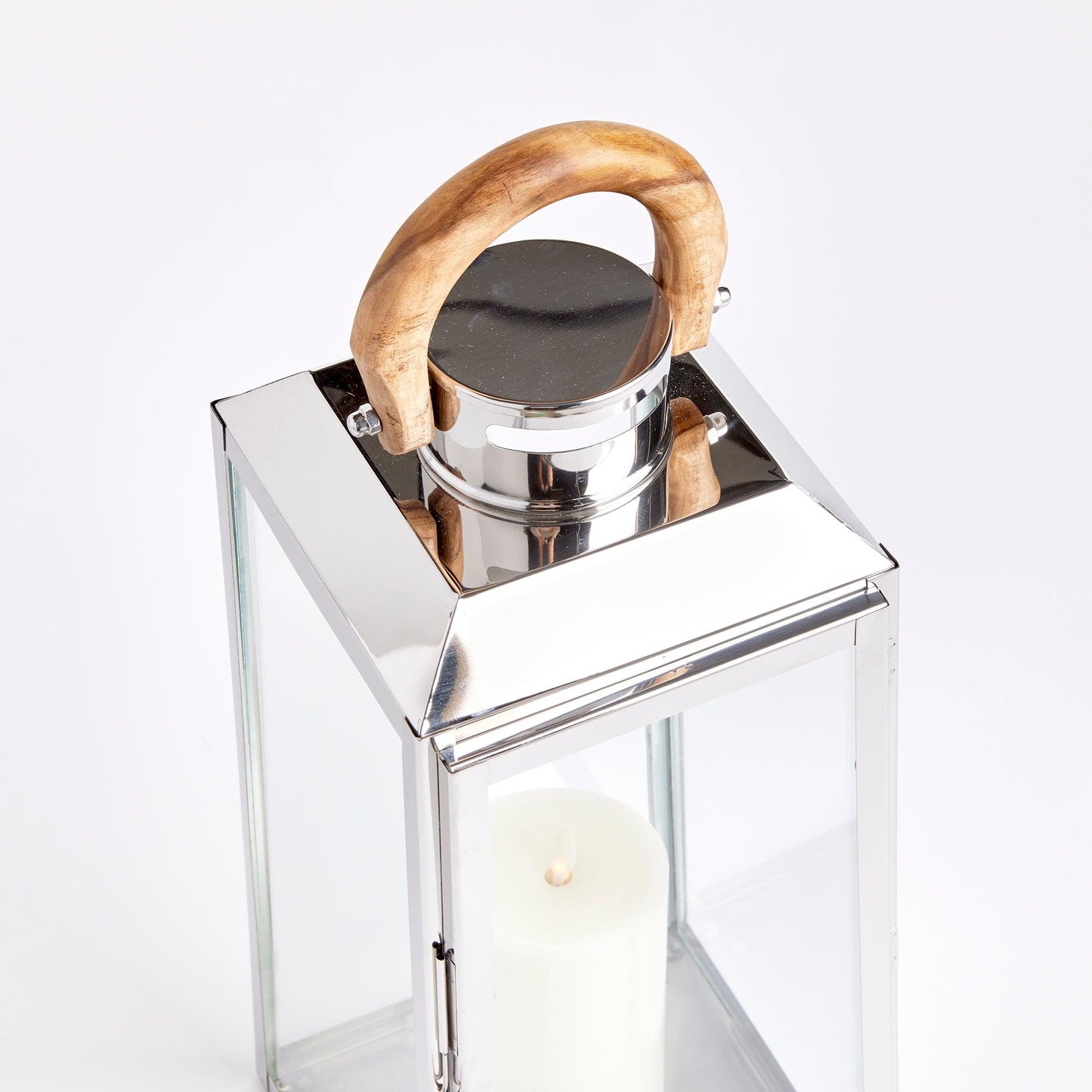 a candle and a glass container with a wooden handle